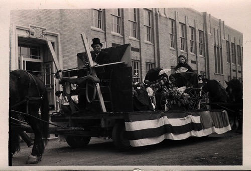 Baby Carriage Float in front of 1935 Chester High School entering 100th Hambletonian Anniversary Parade. Mike Price driving; Mary Roche, standing; Helen Diffily, next to her. Thursday May 5, 1949. chs-003496